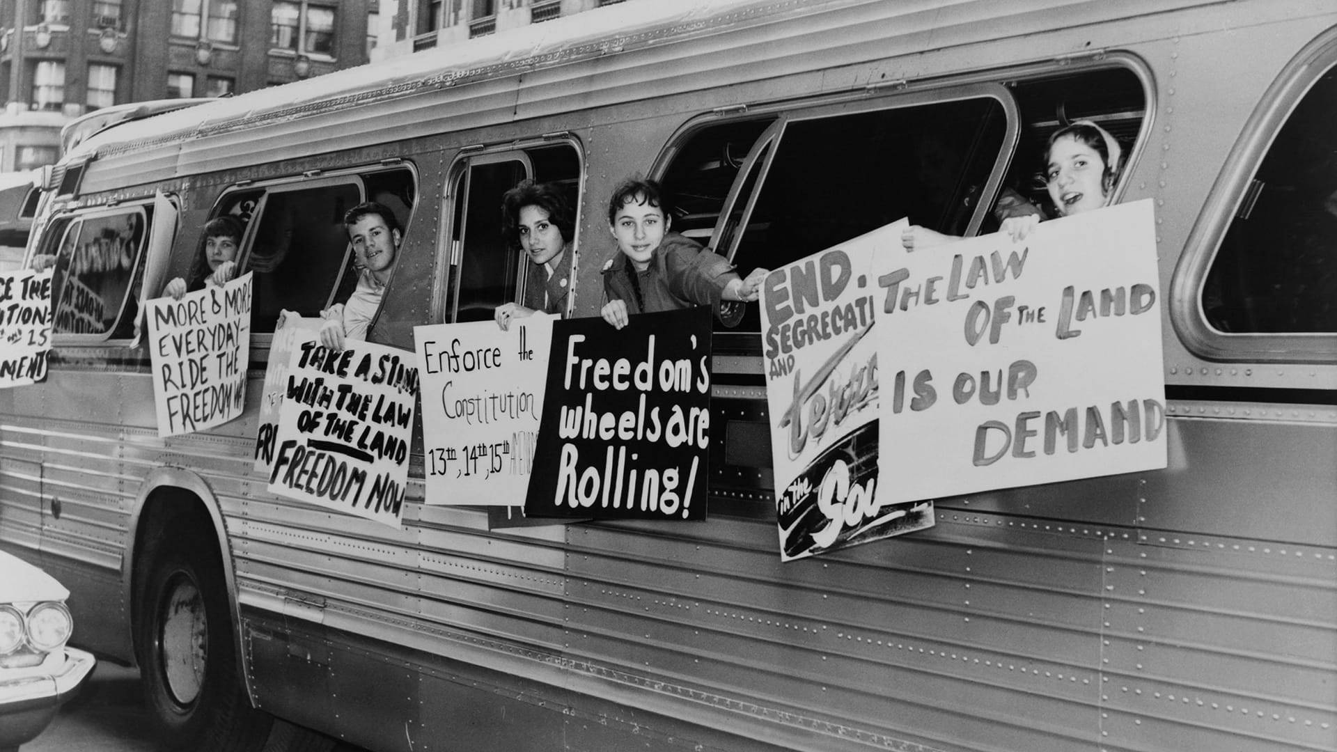Members of the 'Washington Freedom Riders Committee,' hang signs from bus windows to protest
